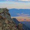 Stanford Earth alum Hari Mix standing atop the Sierra Nevada