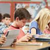 schoolchildren in a classroom reading at their desks