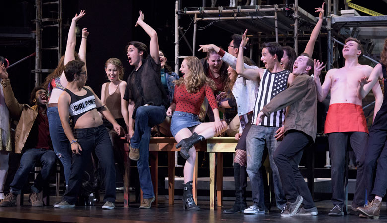 scene with cast members of Rent across the stage