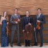 Four people holding their instruments