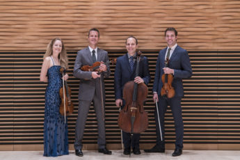 Four people holding their instruments