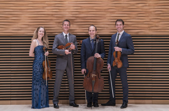 Four people holding their instruments 