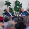 Three members of a panel in front of an audience.