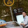 Man standing by car in China