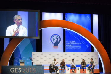 shot of stage at Memorial Auditorium; young entrepreneur panelists flanked by President Obama and Mark Zuckerberg