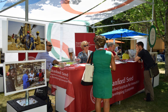 Two people talking at a booth in the Innovation Marketplace.