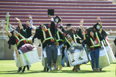 A group of students wear costumes that simulate a roller coaster.