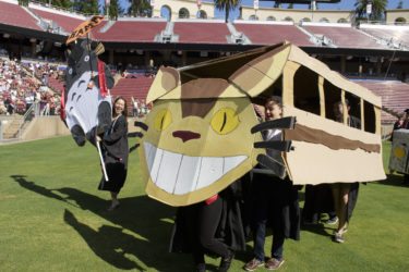 Students dress as their favorite animated charaters walk in the procession