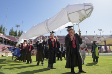 Wyatt Smith, right, and Schuyler Smith and many others carry a long, long, rendition of the space shuttle at Wacky Walk