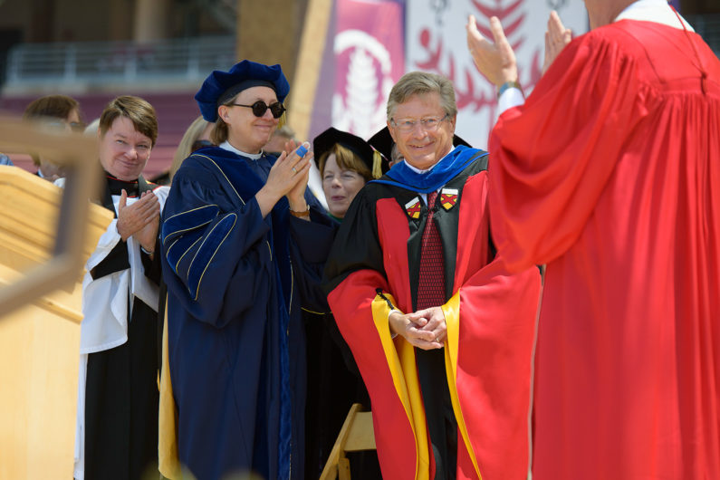 John Etchemendy rising from his seat on stage as he is honored