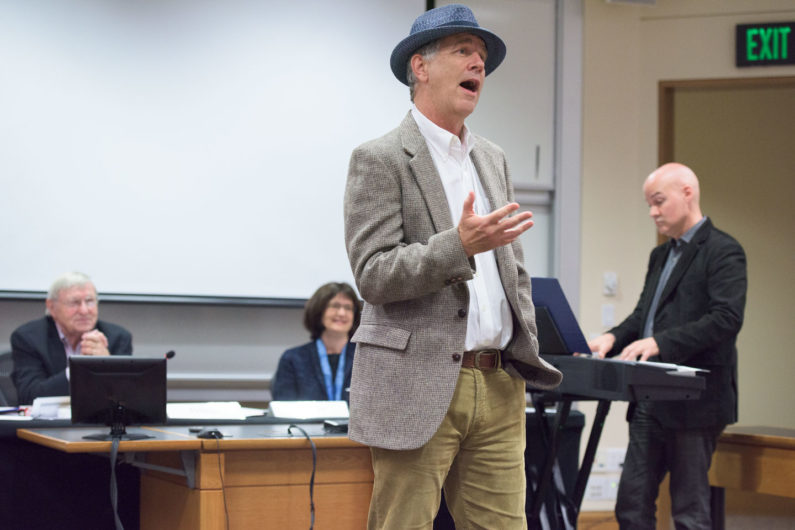 Senate Vice Chair James Campbell singing at the Faculty Senate meeting