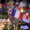 French flag amid candles and flowers