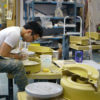 student at a pottery wheel