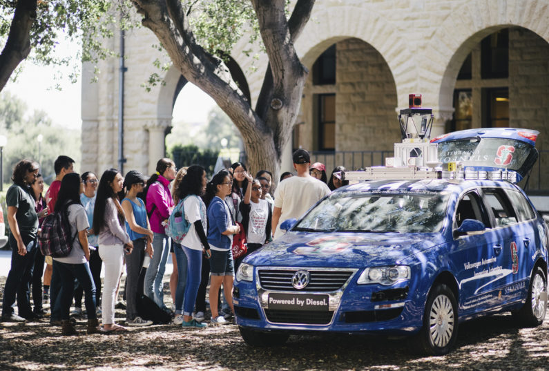 Students gathering at demonstration of an autonomous car