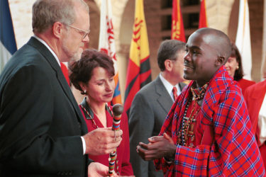 John Hennessy accepts congratulaitons from student Kimeli Willson Naiyomah in Maasai regalia