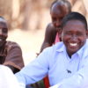 smiling Tom Lalampaa among a group of people