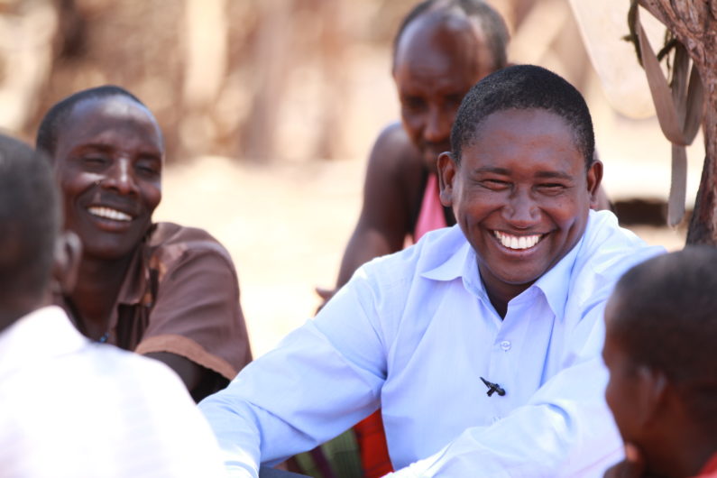 smiling Tom Lalampaa among a group of people