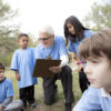 Older man coaching young children.