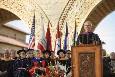 Marc Tessier-Lavigne at podium with other Stanford officials seated.