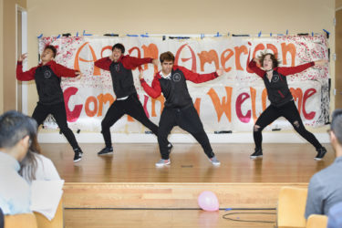 Four performers dancing on stage.