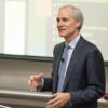 Marc Tessier-Lavigne standing in front of a screen displaying his PowerPoint slides.