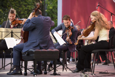 The quartet seated and performing.