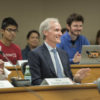 Marc Tessier-Lavigne seated with others around him.