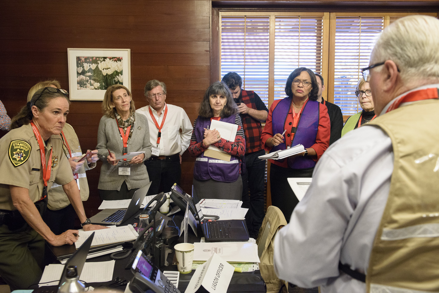 Participants in the Emergency Operations Center listen to Associate Vice Provost for Environmental Health and Safety Larry Gibbs, right, as the exercise moves to a close.