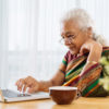 Elderly woman using computer