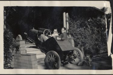 students driving a car up the stairs to a house in 1929