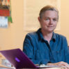 portrait of Susan Holmes, professor of statistics, at desk with laptop computer