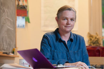 portrait of Susan Holmes, professor of statistics, at desk with laptop computer