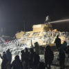 Law enforcement personnel fire a water canon at Standing Rock protesters in sub-zero temperature.