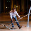 Sculptor Will Clift adjusts the placement of his sculpture before a rehearsal at the Bing Concert Hall.