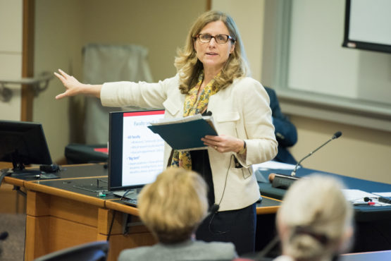 M. Elizabeth Magill standing in front of the Faculty Senate.