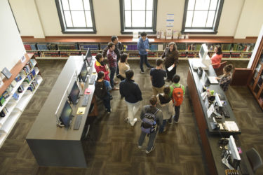 Librarian leads students on an orientation of the Li & Ma Science Library