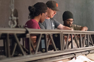 Lead carpenter Daniel Cadigan works with student carpenters Ewea Tseumah and Stewart Gray III on a production of Shakespeare’s The Tempest.