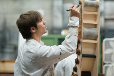 Student carpenter Zachary Dammann paints a corbel for the set of a production of Shakespeare’s The Tempest.