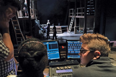 Lighting designer James Sherwood with students at the lighting board