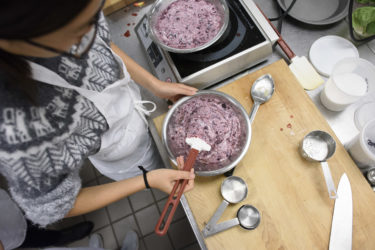 student stirring pie filling