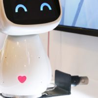 A cute robot with a heart on its belly.