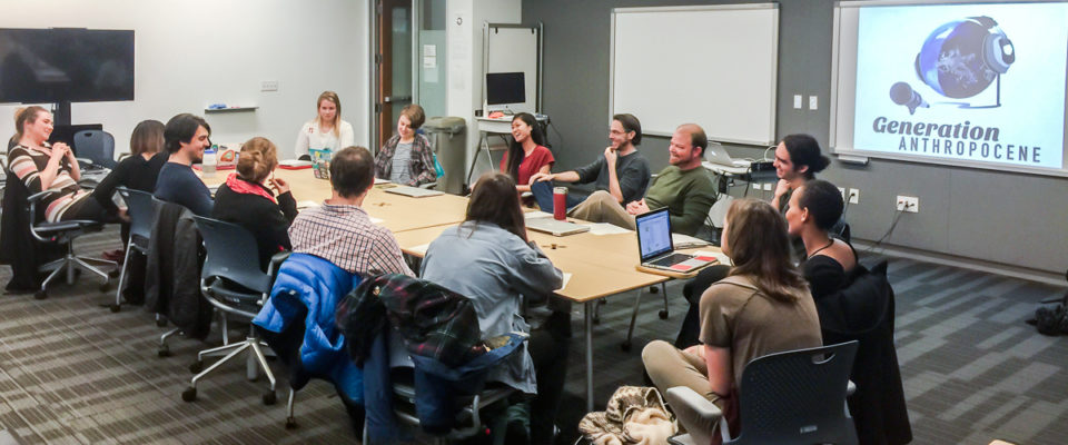 Podcasting the Anthropocene class gathered around a table in the classroom