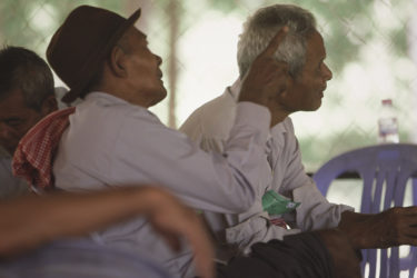 three Cambodian men, seated