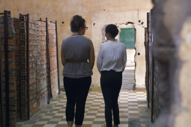 two women walking away down a hallway