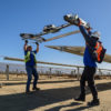 Workers cleaning solar panels