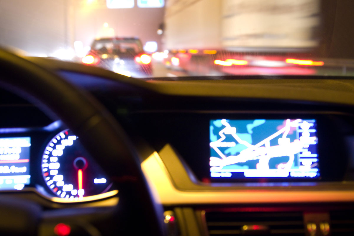 car dashboard and navigation system illuminated at night