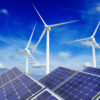 Solar panels and wind turbines against a blue sky