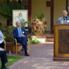 Reyno “Rey” Peralta at podium after receiving Amy J Blue Award; photo of Amy Blue in background