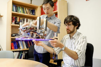 Hao Jiang, graduate student in the Cutkosky lab and lead author of the paper and Elliot Hawkes, MS ‘11, PhD ‘15, a visiting assistant professor from the University of California, Santa Barbara and co-author of the paper, hold the custom robotic gripper.