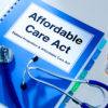 photo of a binder titled Affordable Care Act with stethoscope, pill bottle